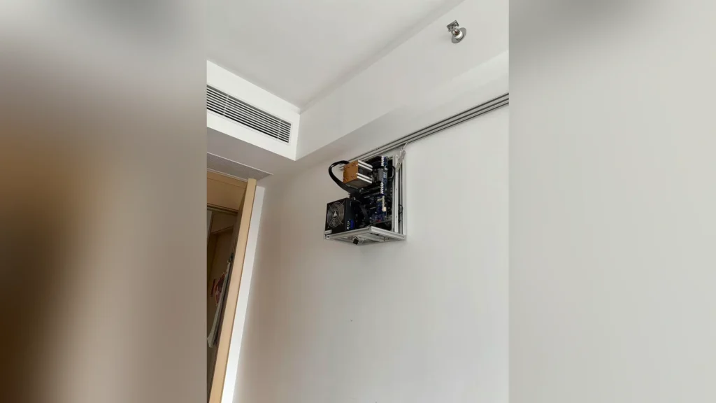 Enthusiast Mounts Open-Frame PC Under AC Vent 1 Close-up of the structural aluminum profiles and guide rails holding the wall-mounted PC.