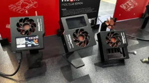 Three Thermal Grizzly WireView Pro II Noctua Edition power monitoring units displayed at a Computex trade show booth.