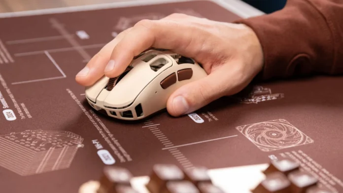 Hand gripping the Pulsar Feinmann F01 Noctua Edition gaming mouse during use.