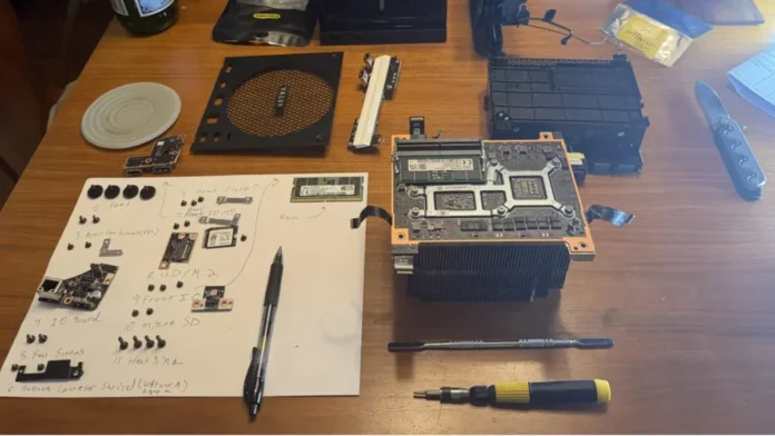 Disassembled Steam Machine with RAM module, tools, and internal components laid out during a memory upgrade.