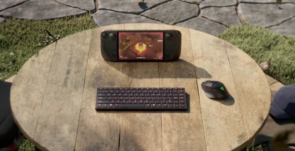 Razer Travel Case Folio with a handheld gaming console, compact keyboard, and wireless mouse on an outdoor table.
