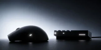 Wallhack M-001 Teased With Swappable Battery and Charging Dock Side profile of the Wallhack M-001 gaming mouse placed next to its charging dock with illuminated status LEDs